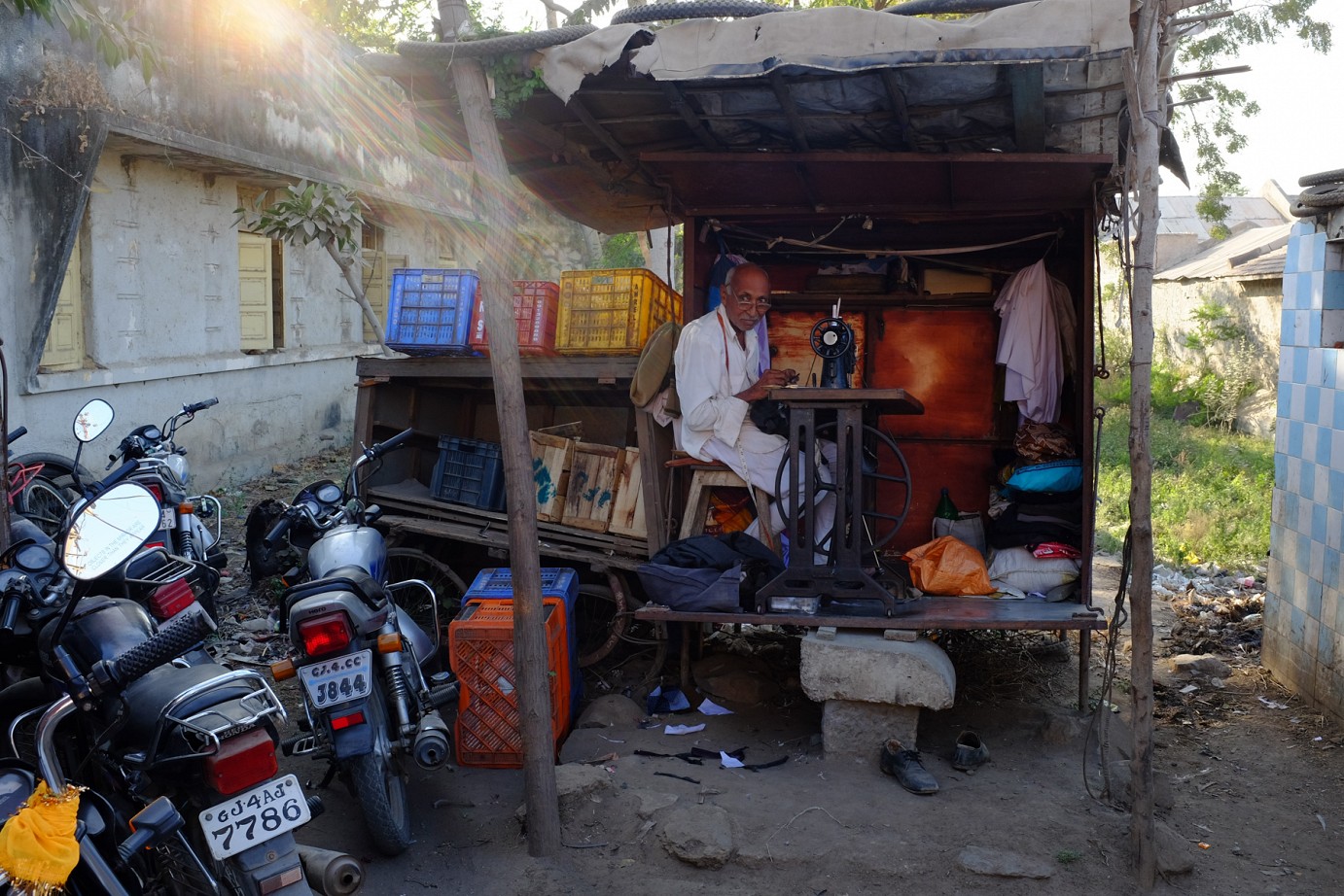 elderly tailor in his shack-workshop